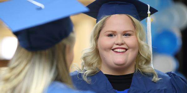 young woman in graduation cap and gown